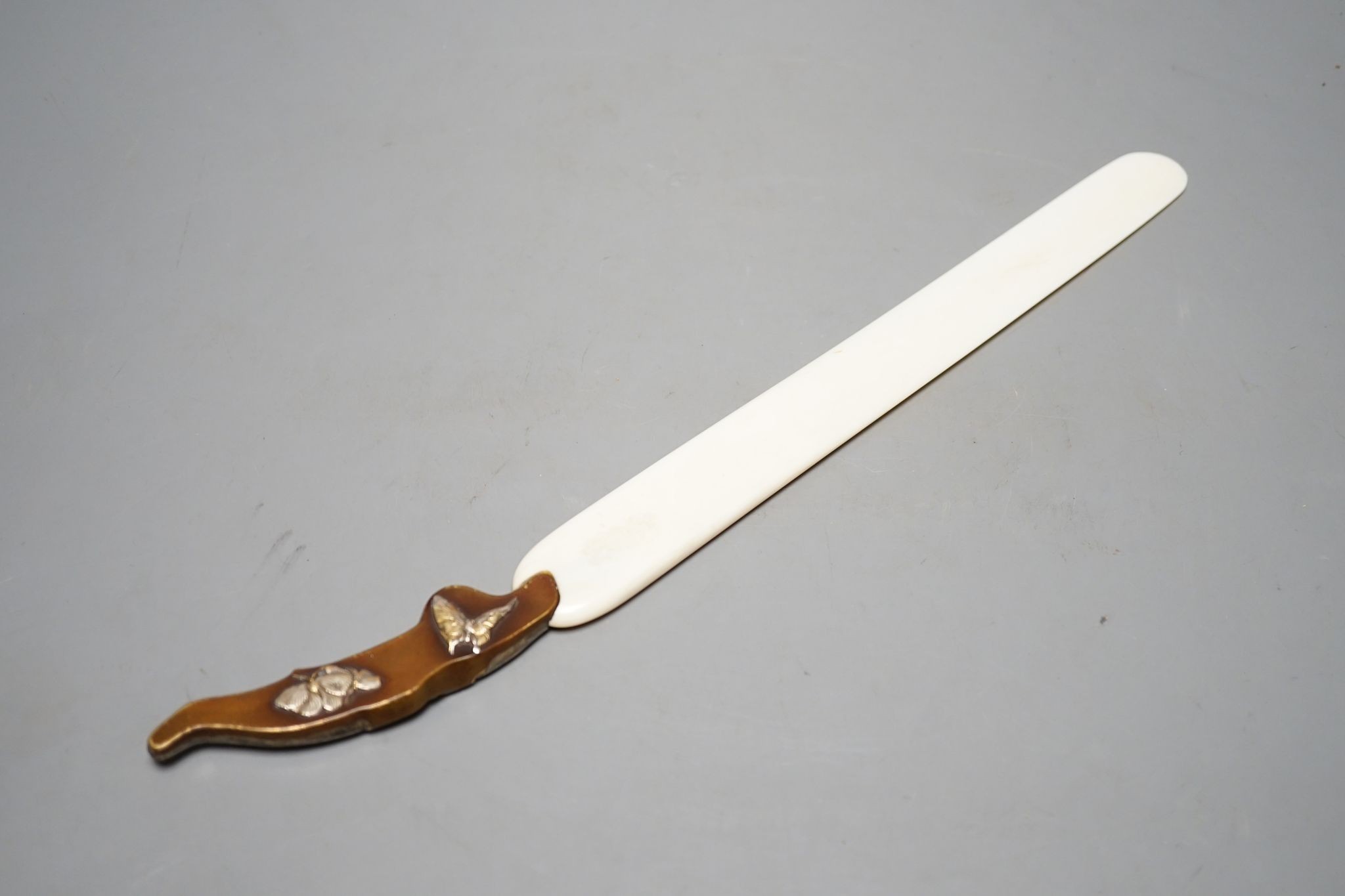 A Japanese mixed metal and ivory page turner, early 20th century, 38 cms long.